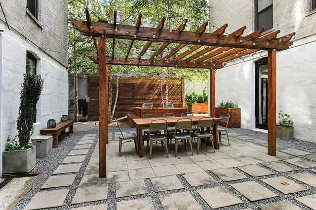 a living room with furniture a rug and a floor to ceiling window