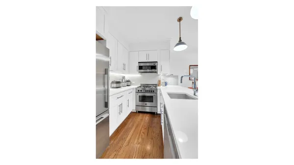 a kitchen with a sink and appliances