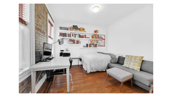 a living room with furniture and a book shelf