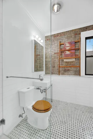 a bathroom with a toilet and a shower