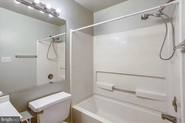 a bathroom with a shower a toilet and a shower