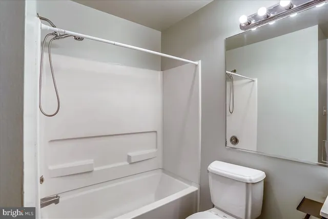 a bathroom with a shower a toilet and a shower