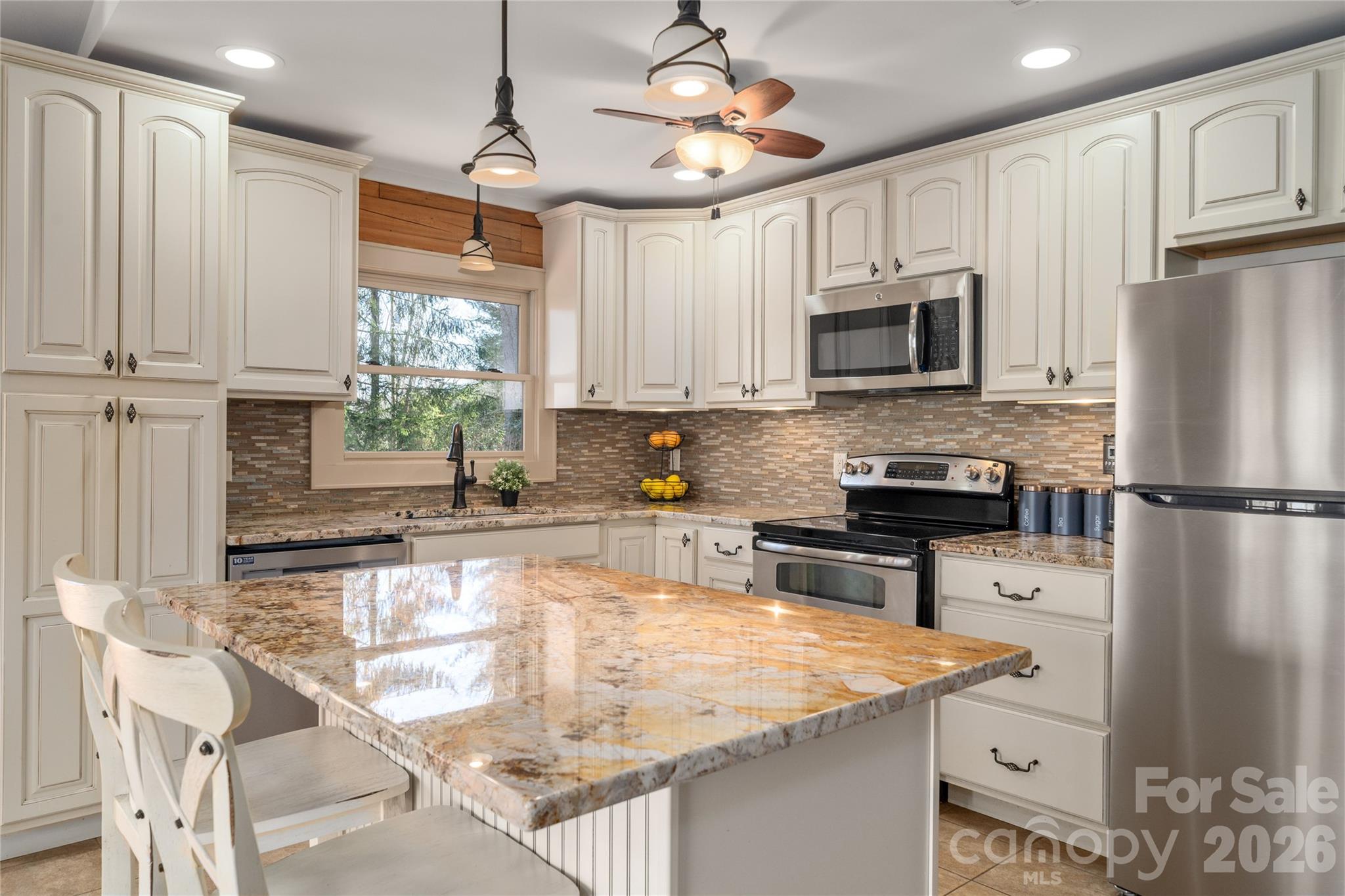 37 Cherokee Trail Fletcher, NC 28732 - Photo 5 of 34 a kitchen with stainless steel appliances granite countertop a sink a stove a refrigerator cabinets and a window