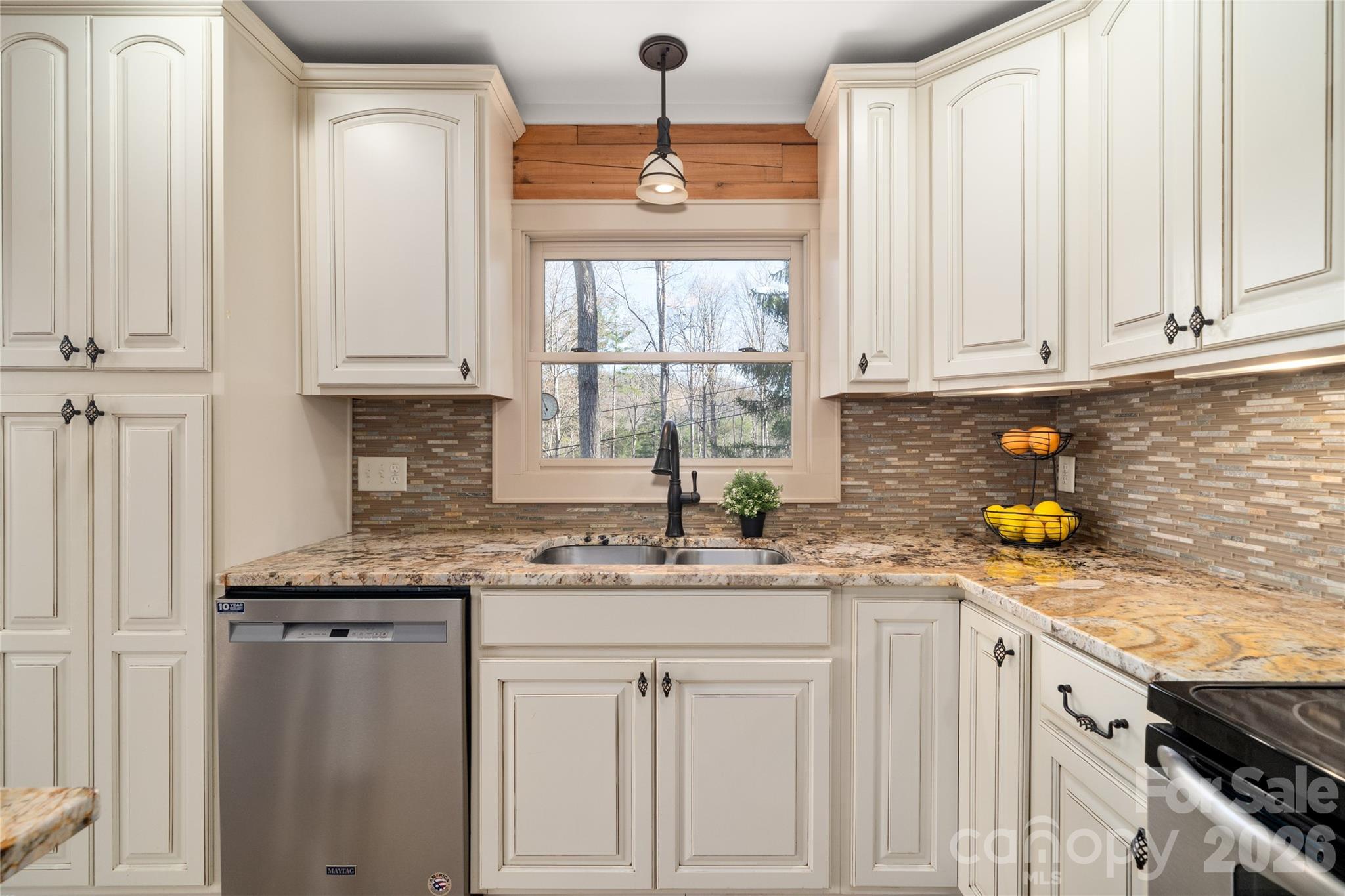 37 Cherokee Trail Fletcher, NC 28732 - Photo 6 of 34 a kitchen with stainless steel appliances granite countertop a sink a stove cabinets and a window