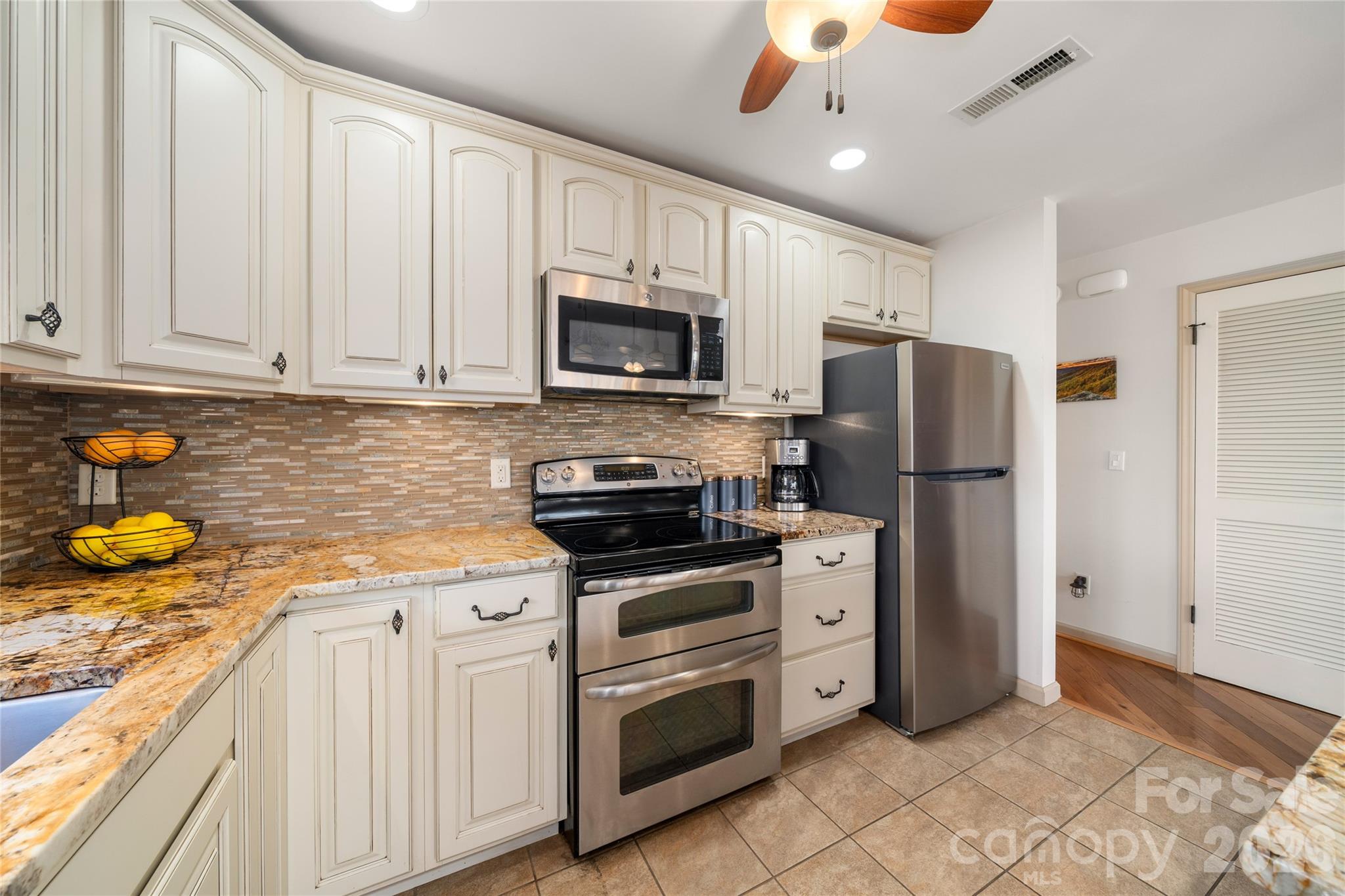 37 Cherokee Trail Fletcher, NC 28732 - Photo 7 of 34 a kitchen with stainless steel appliances granite countertop a refrigerator oven a stove top oven a sink and dishwasher