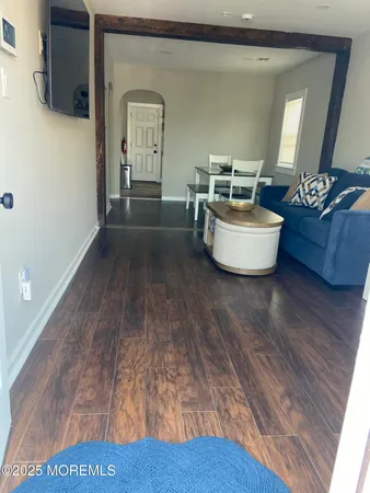 a room with wooden floor and furniture