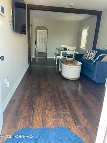 a room with wooden floor and furniture