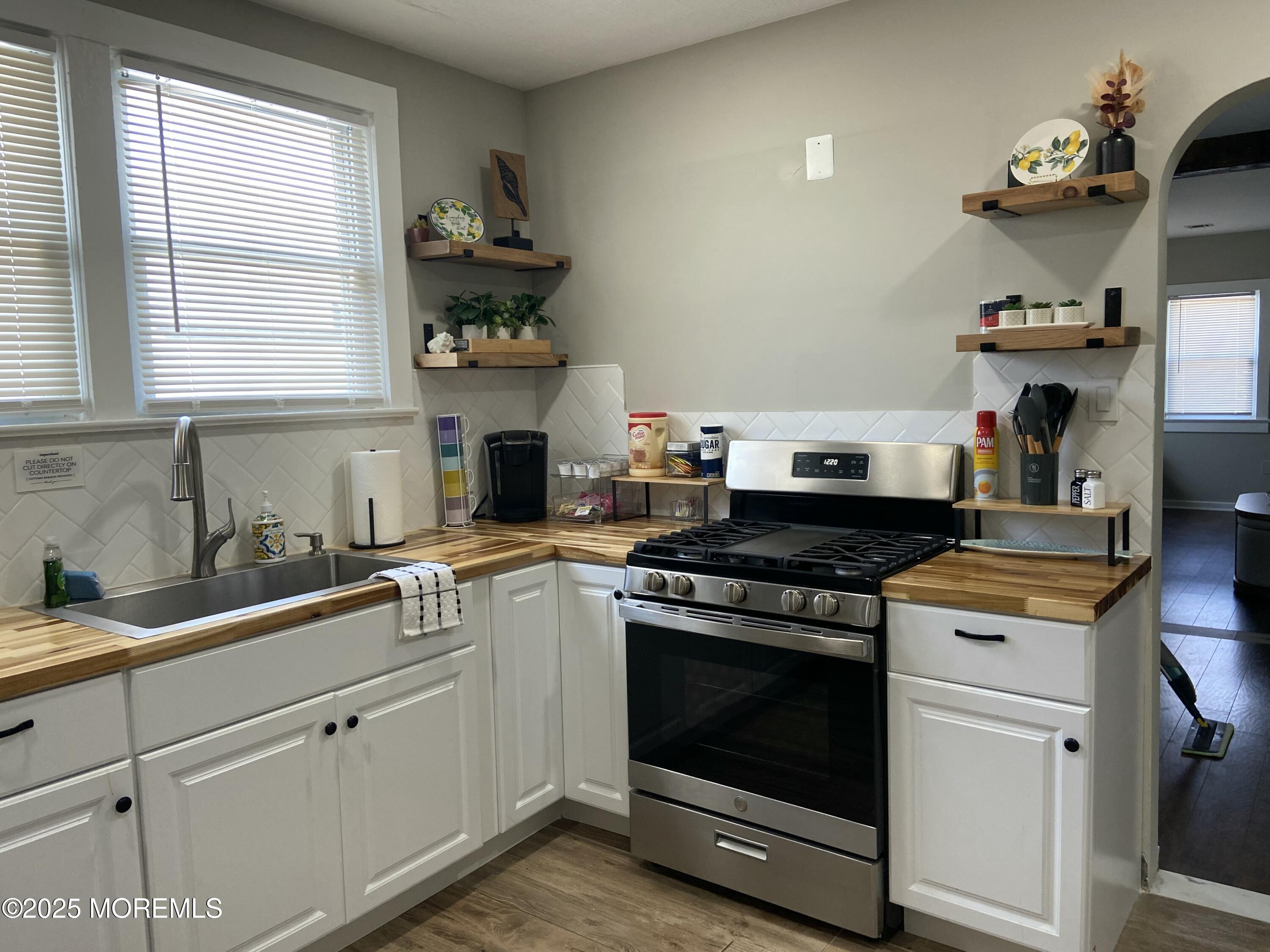 215 Webster Avenue, Unit 2 Seaside Heights, NJ 08751 - Photo 3 of 10 a kitchen with cabinets appliances and a window