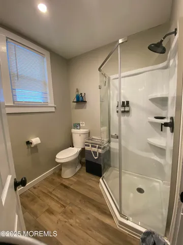 a bathroom with a toilet and a shower