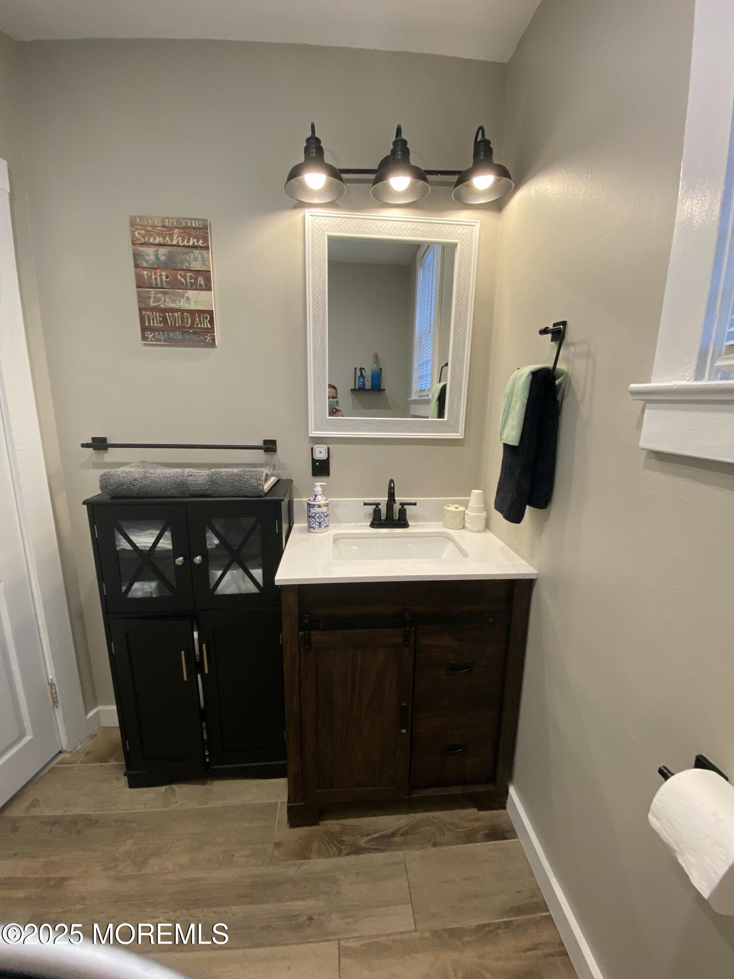215 Webster Avenue, Unit 2 Seaside Heights, NJ 08751 - Photo 5 of 10 a bathroom with a sink and a mirror
