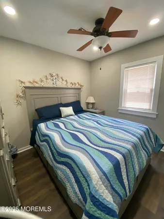 a bedroom with a bed and a ceiling fan