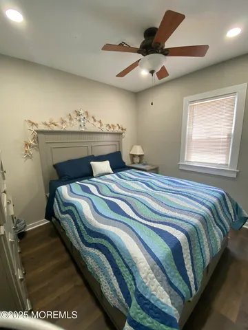 a bedroom with a bed and a ceiling fan
