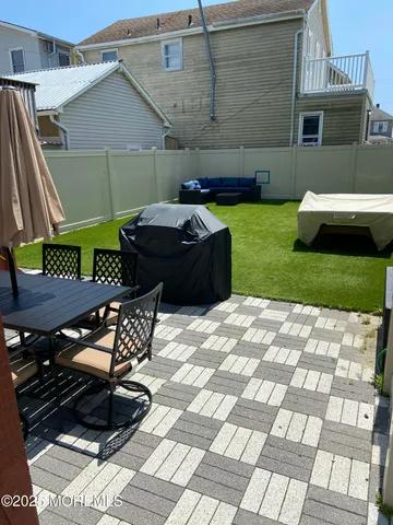 a backyard of a house with table and chairs