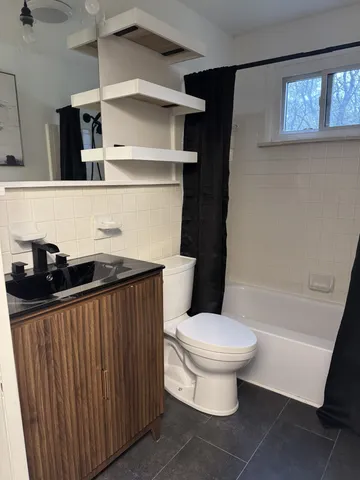 a bathroom with a sink a toilet and a bathtub