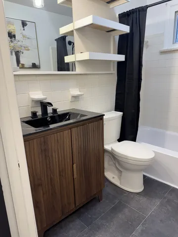 a bathroom with a sink a toilet and vanity