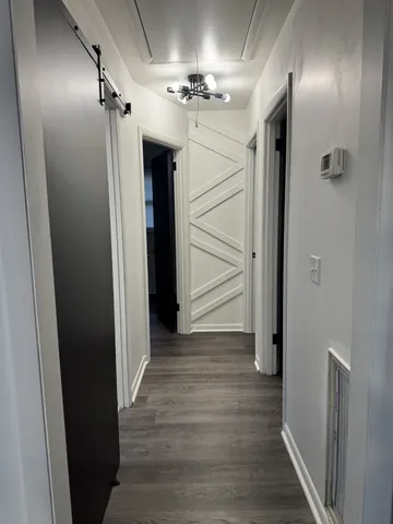 a view of a hallway with wooden floor
