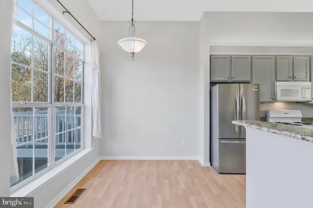 a kitchen with a refrigerator a sink and cabinets
