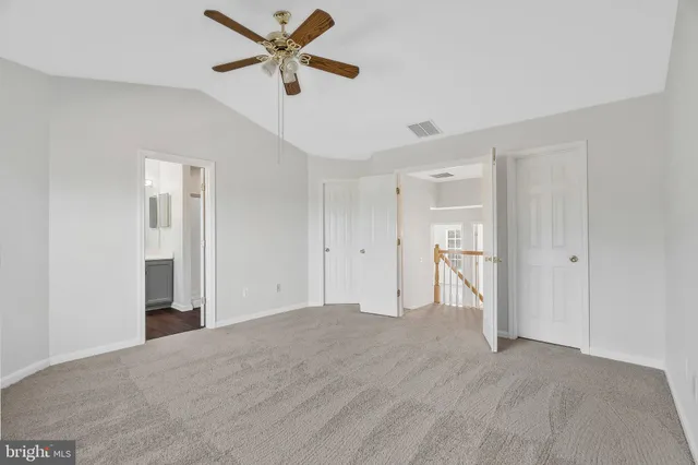 a view of empty room with ceiling fan
