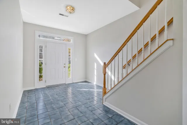 a view of an entryway with wooden floor