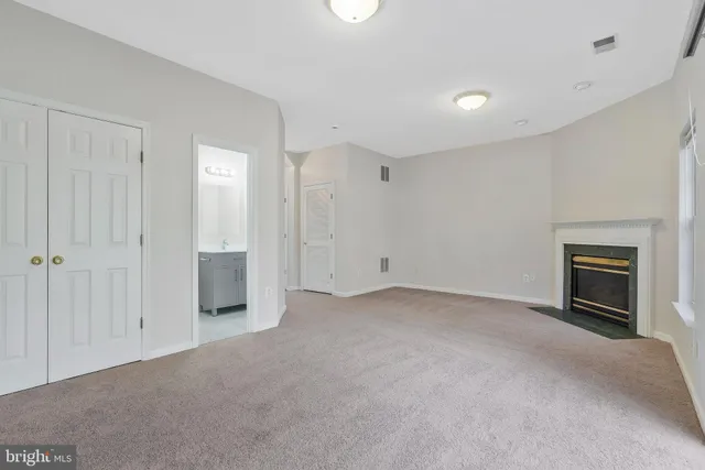 a view of empty room with a fireplace