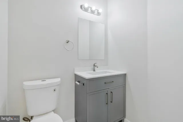 a bathroom with a toilet sink and mirror