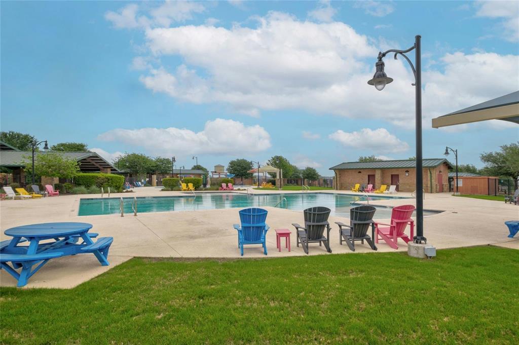 208 Orange Road Buda, TX 78610 - Photo 27 of 31 A refreshing outdoor community pool area, offering a perfect oasis for leisure and enjoyment.