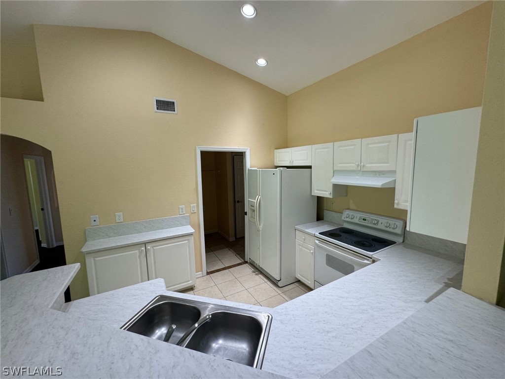 1841 Landale Loop Lehigh Acres, FL 33972 - Photo 4 of 21 a kitchen with a sink and refrigerator