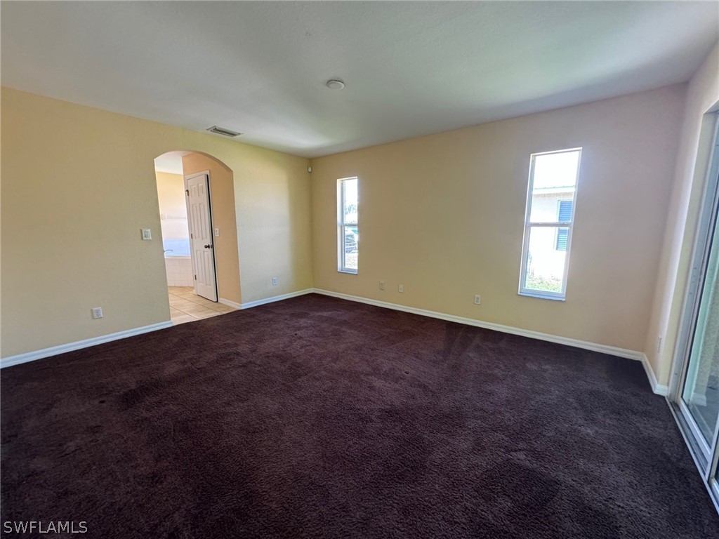 1841 Landale Loop Lehigh Acres, FL 33972 - Photo 7 of 21 an empty room with windows and closet