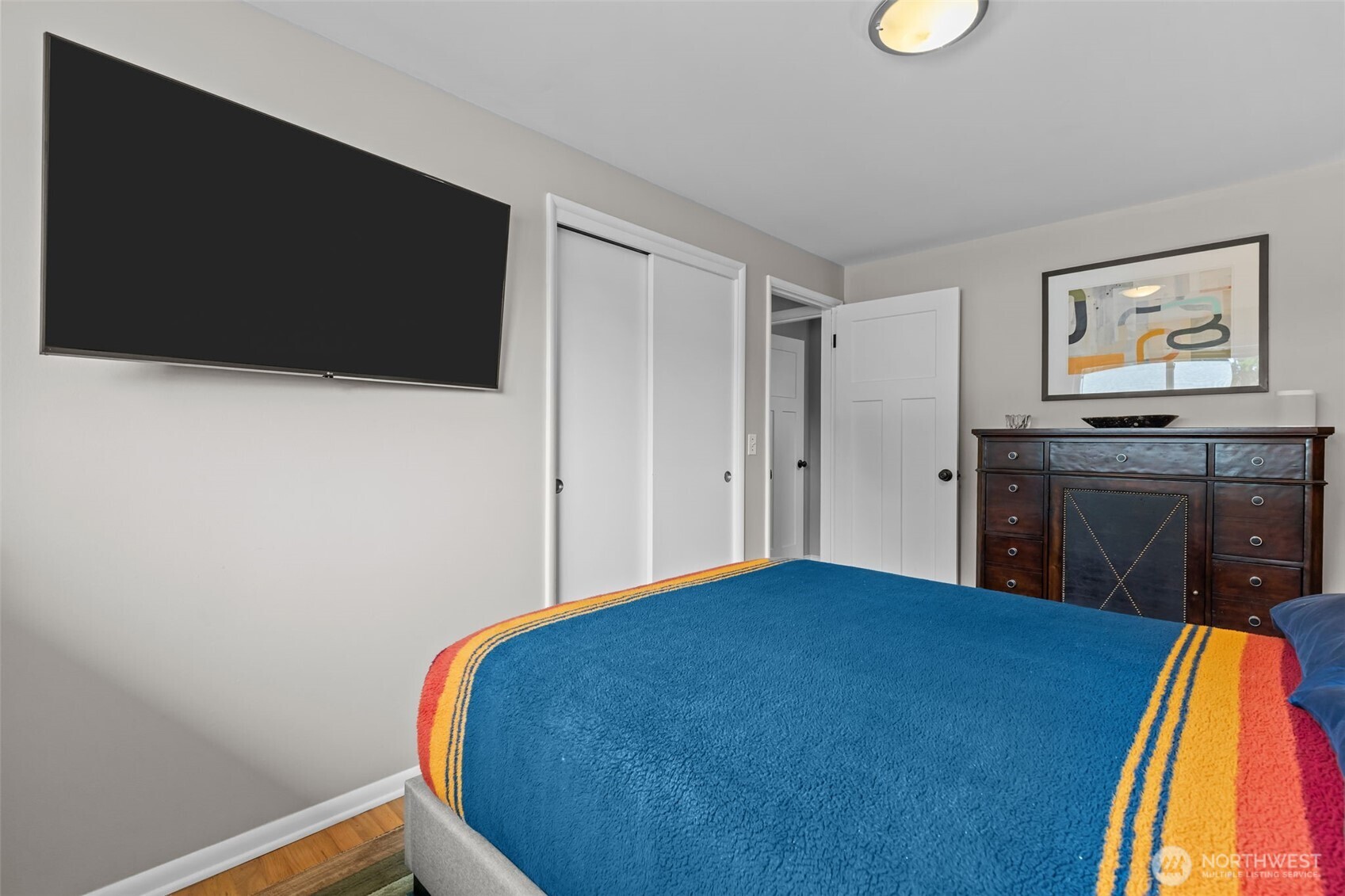 11462 35th Avenue Southwest Seattle, WA 98146 - Photo 11 of 26 a bed room with a bed and a television