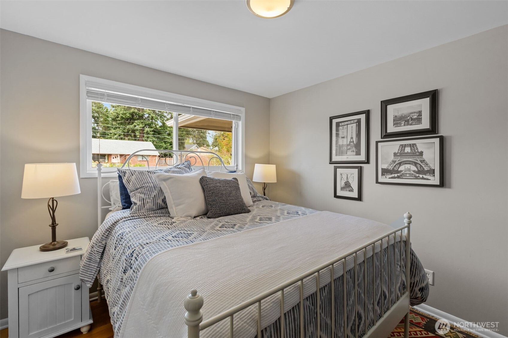 11462 35th Avenue Southwest Seattle, WA 98146 - Photo 12 of 26 a bedroom with a bed and a lamp on table