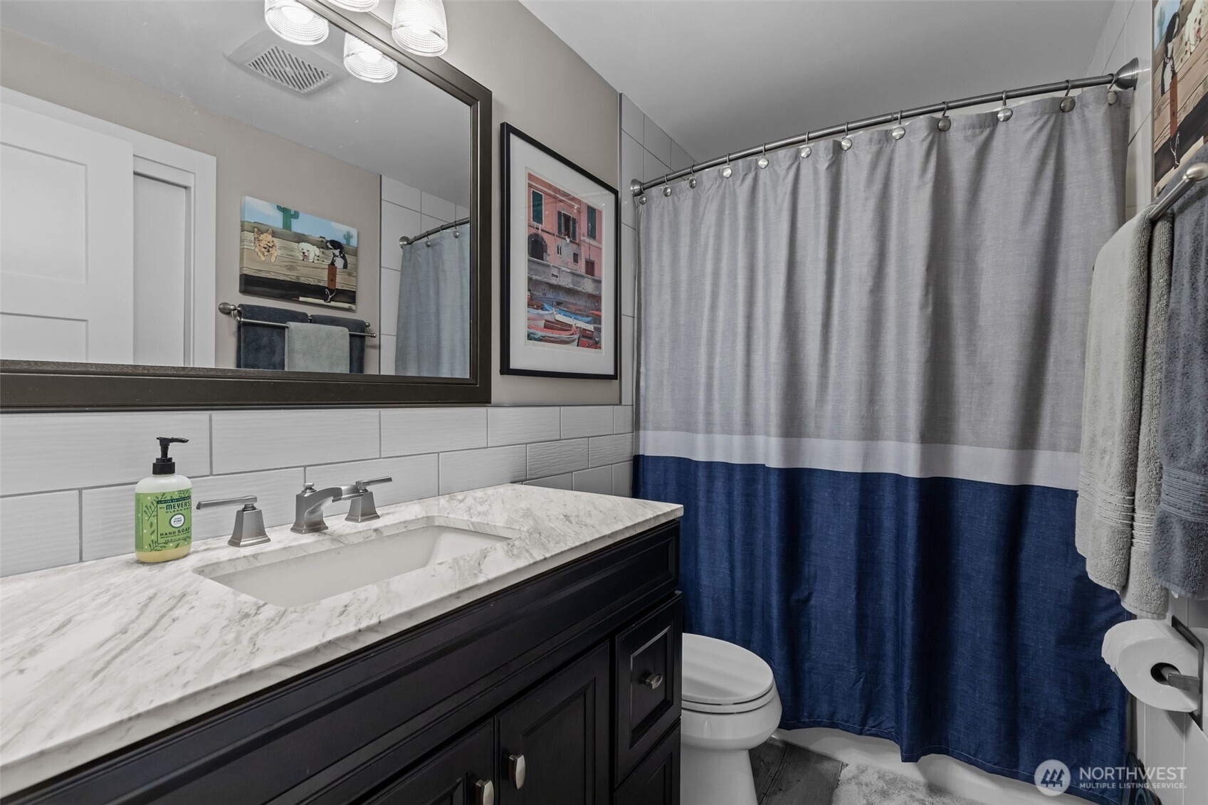 11462 35th Avenue Southwest Seattle, WA 98146 - Photo 16 of 26 a bathroom with a granite countertop sink and a mirror
