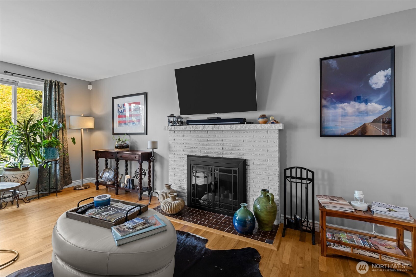 11462 35th Avenue Southwest Seattle, WA 98146 - Photo 3 of 26 a living room with furniture a flat screen tv and a fireplace