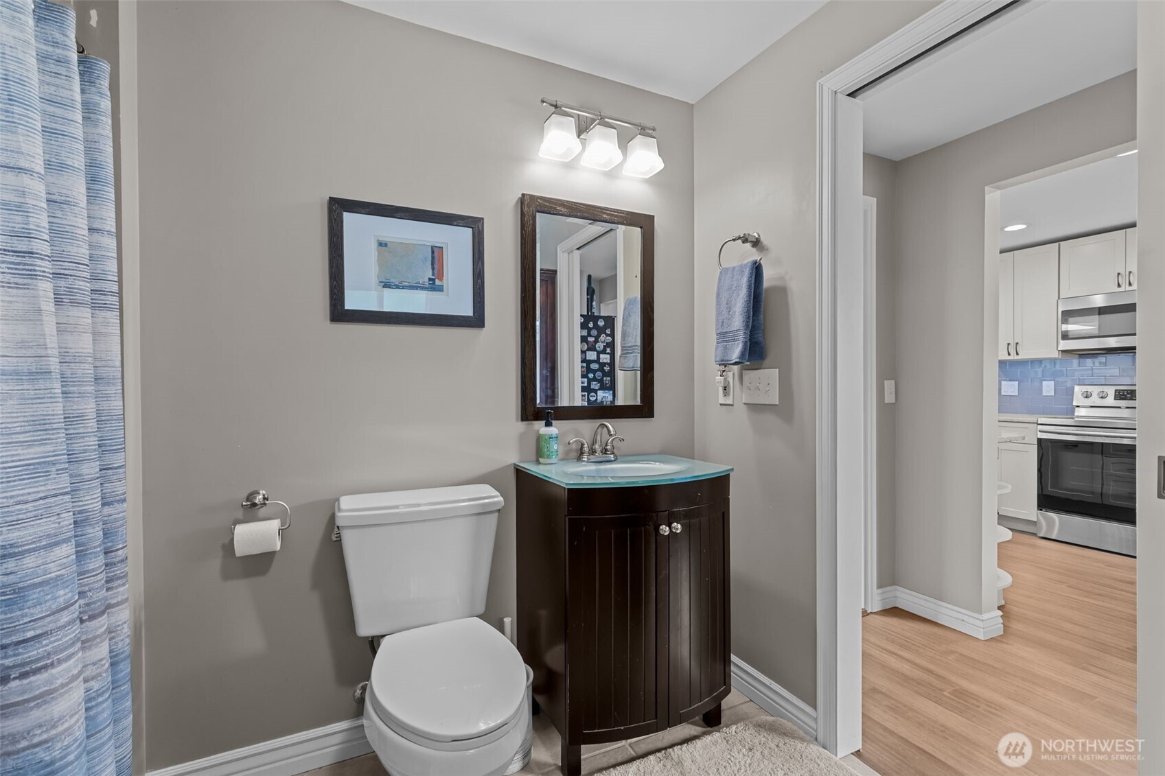 11462 35th Avenue Southwest Seattle, WA 98146 - Photo 7 of 26 a bathroom with a toilet a sink and mirror