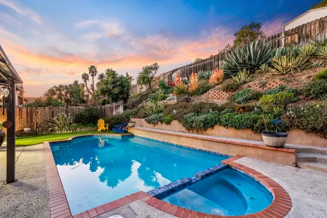 a view of a swimming pool with an outdoor seating and a yard