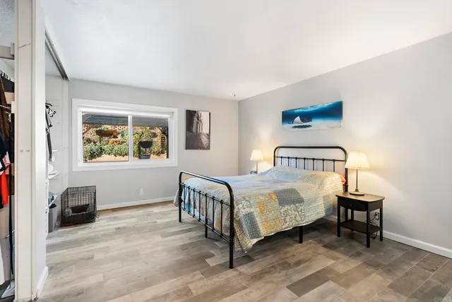 a bedroom with a bed and a window