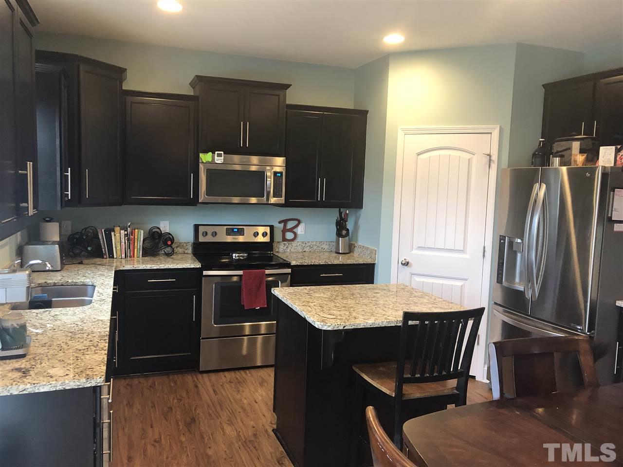 2716 Communion Court Raleigh, NC 27610 - Photo 2 of 17 a kitchen with granite countertop a refrigerator stove and sink