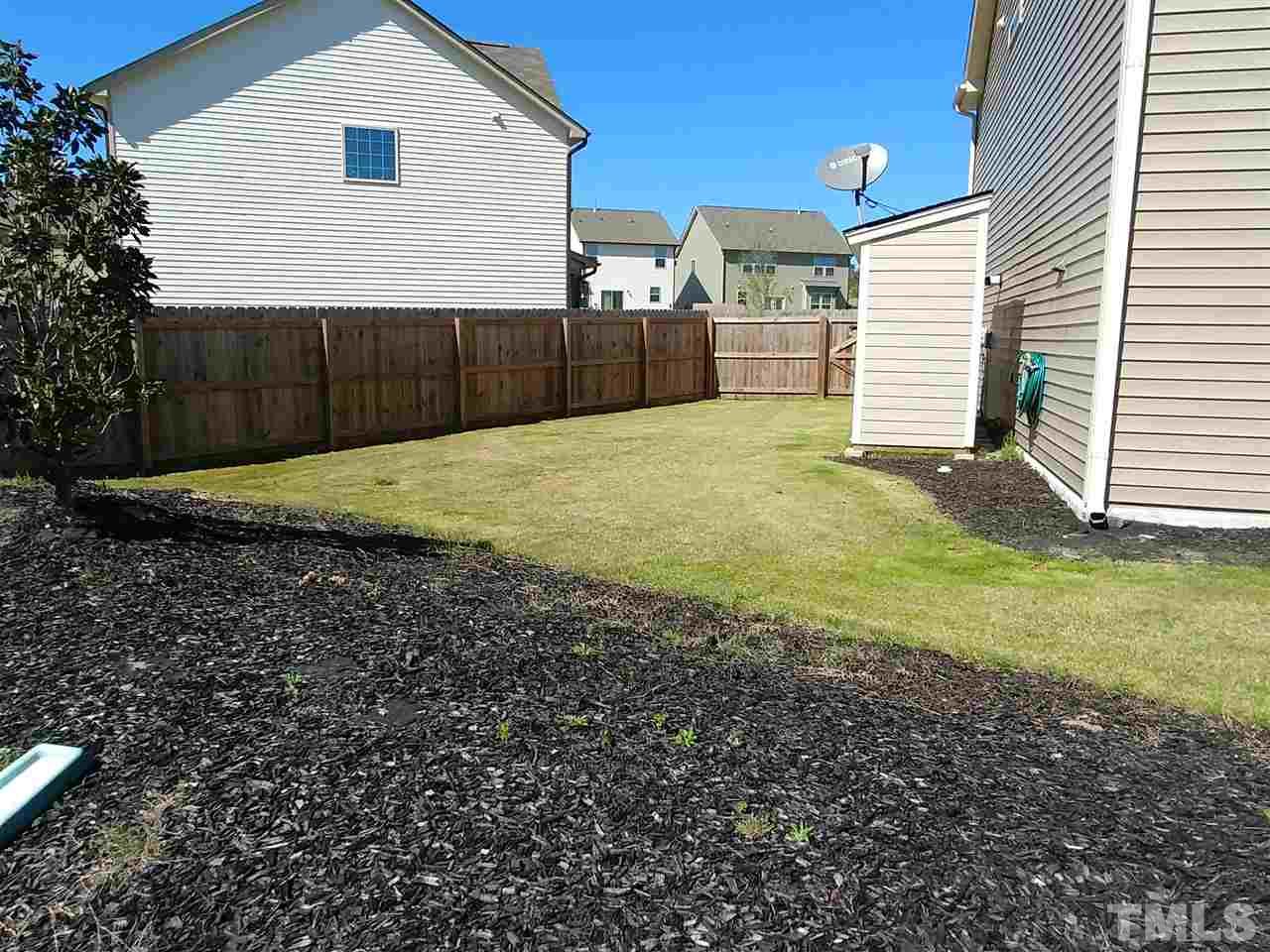 2716 Communion Court Raleigh, NC 27610 - Photo 13 of 17 a view of a backyard with a garden