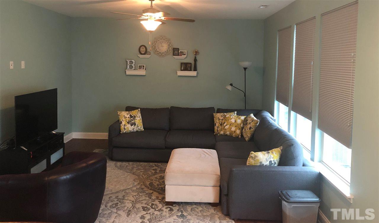 2716 Communion Court Raleigh, NC 27610 - Photo 4 of 17 a living room with furniture and a flat screen tv