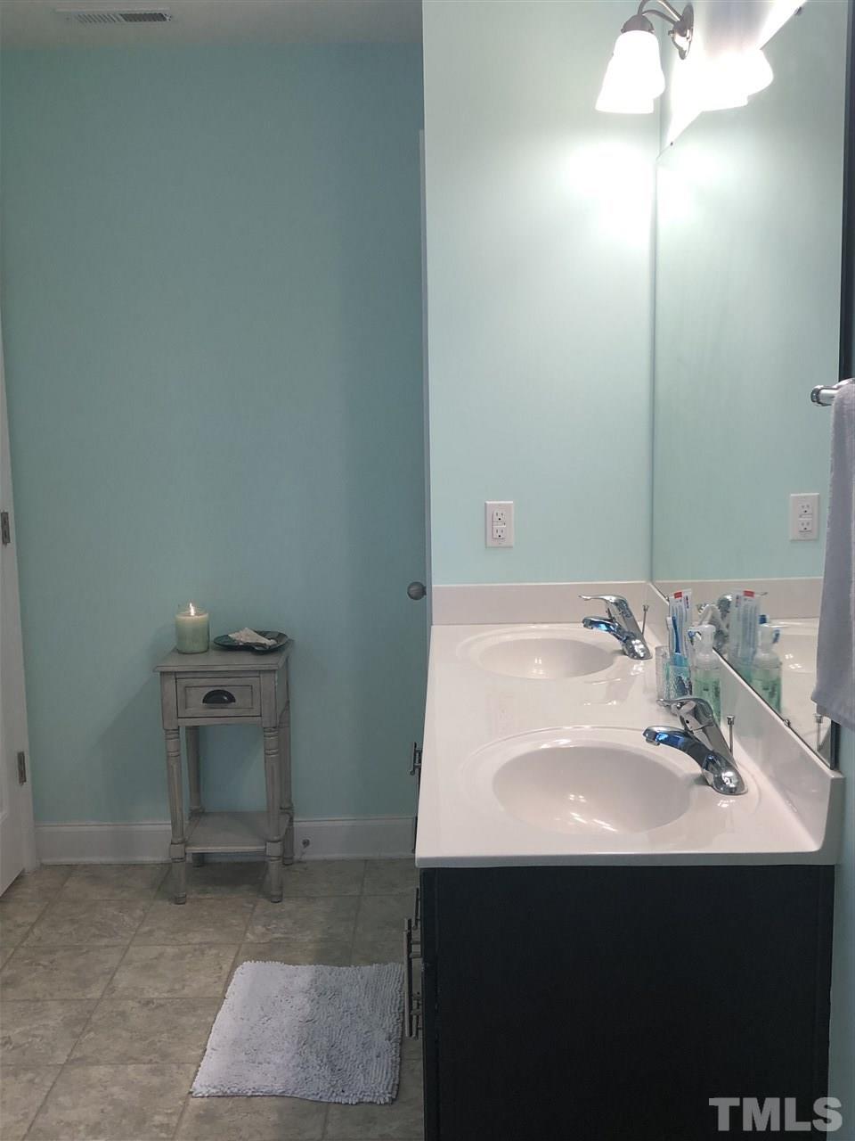 2716 Communion Court Raleigh, NC 27610 - Photo 9 of 17 a bathroom with a sink and a mirror