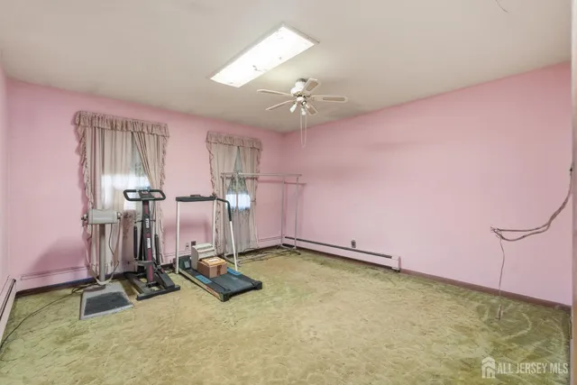 a room with gym equipment and windows
