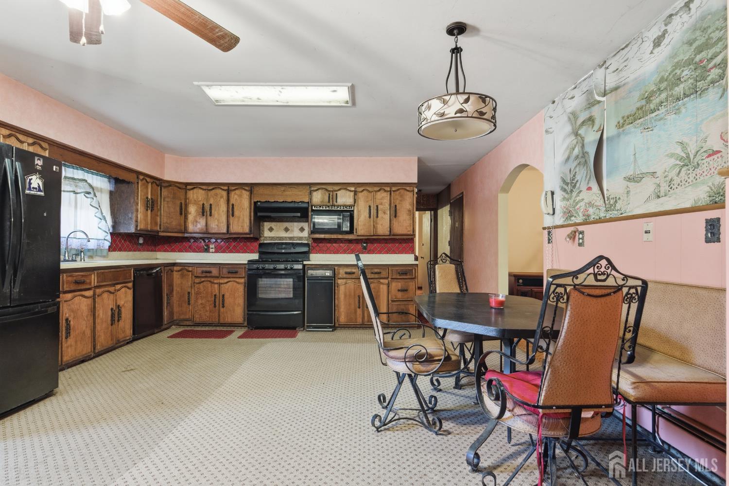 17 Birch Street Old Bridge, NJ 08857 - Photo 7 of 22 a dining room with stainless steel appliances kitchen island granite countertop a table chairs and a view of living room