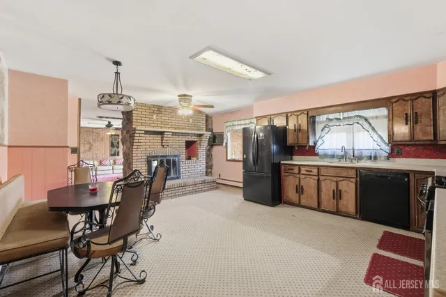 a kitchen with stainless steel appliances kitchen island granite countertop a sink and cabinets