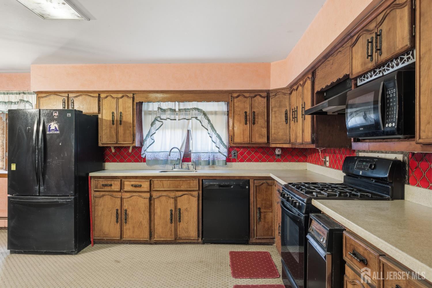 17 Birch Street Old Bridge, NJ 08857 - Photo 9 of 22 a kitchen with stainless steel appliances granite countertop a sink stove and refrigerator