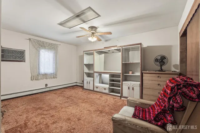 a living room with furniture cabinets and window