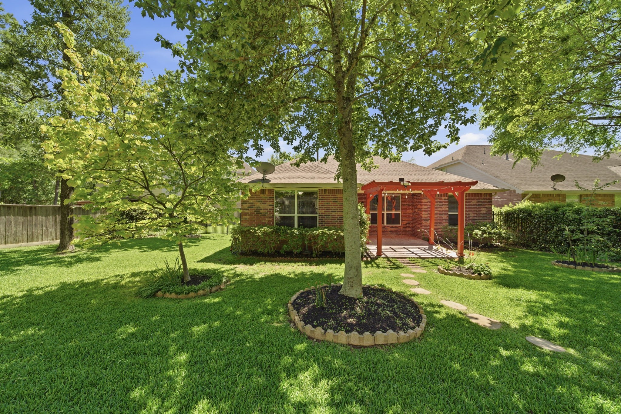 123 North Hawkhurst Circle Magnolia, TX 77354 - Photo 28 of 40 The back yard has lush landscaping, and lots of flowering plants to attract the birds and the butterflies.