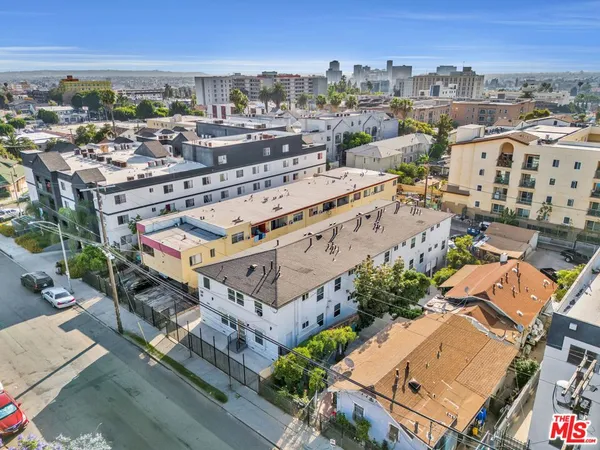 an aerial view of a building with a yard