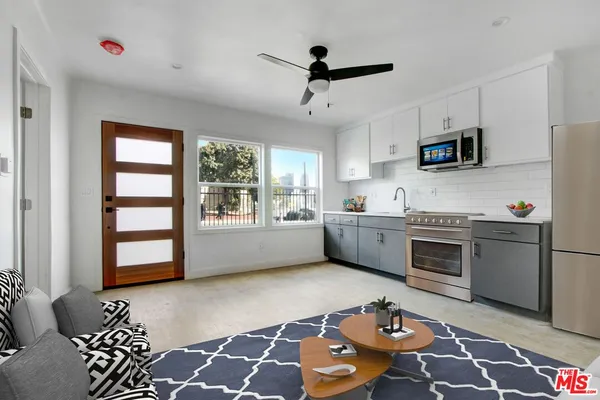 a kitchen with stainless steel appliances a refrigerator sink and cabinets
