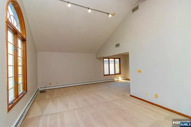 an empty room with windows and entrance