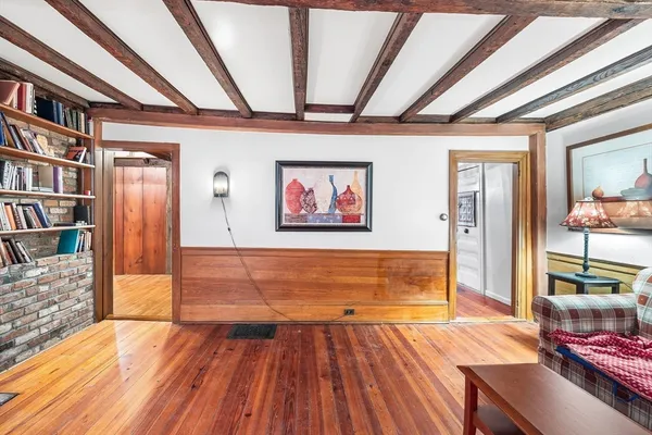 a bedroom with furniture and a wooden floor