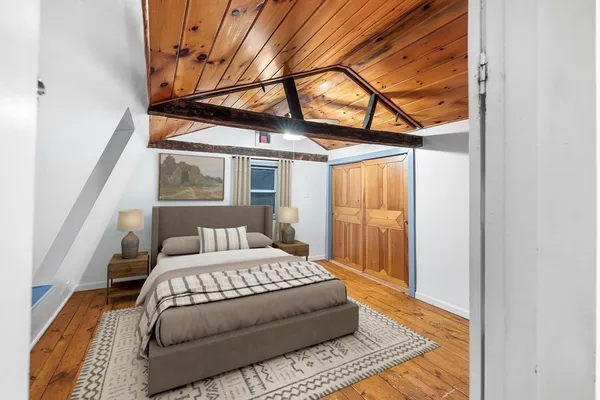 a view of a room with wooden floor and iron stairs